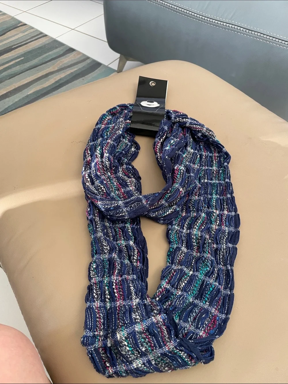 Infinity scarf new in package. Colors blue, red teal and silver. Great accent to